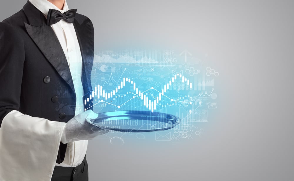 Waiter serving fluctuation concept and charts on a tray Waiter serving fluctuation concept and charts on a tray
